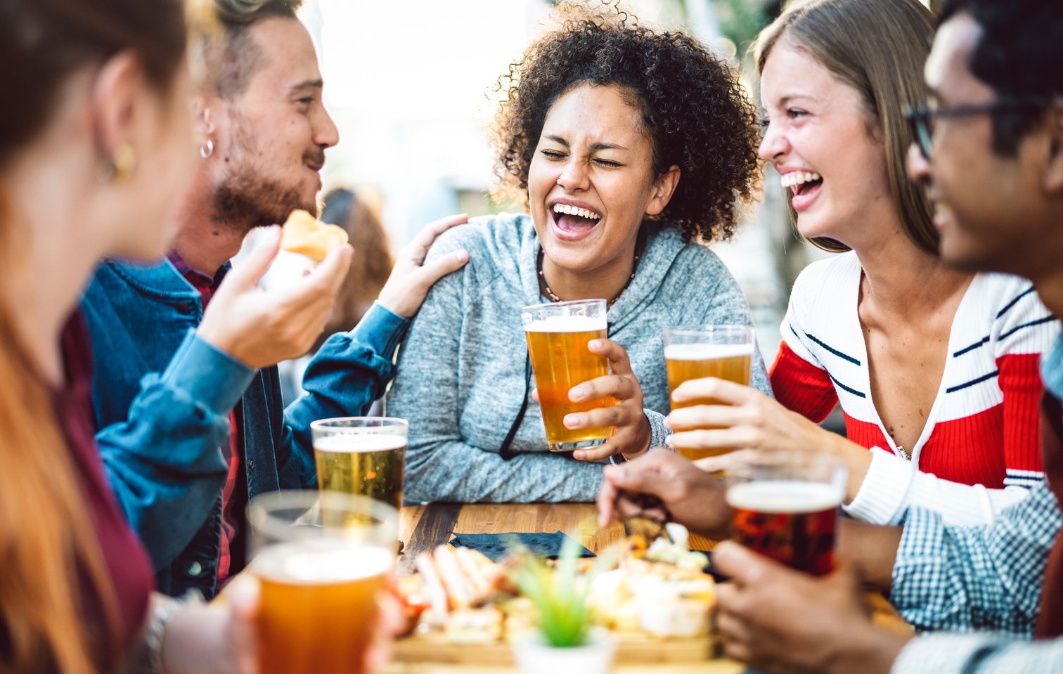 Friends Drinking Beer at Brewery Pub Garden